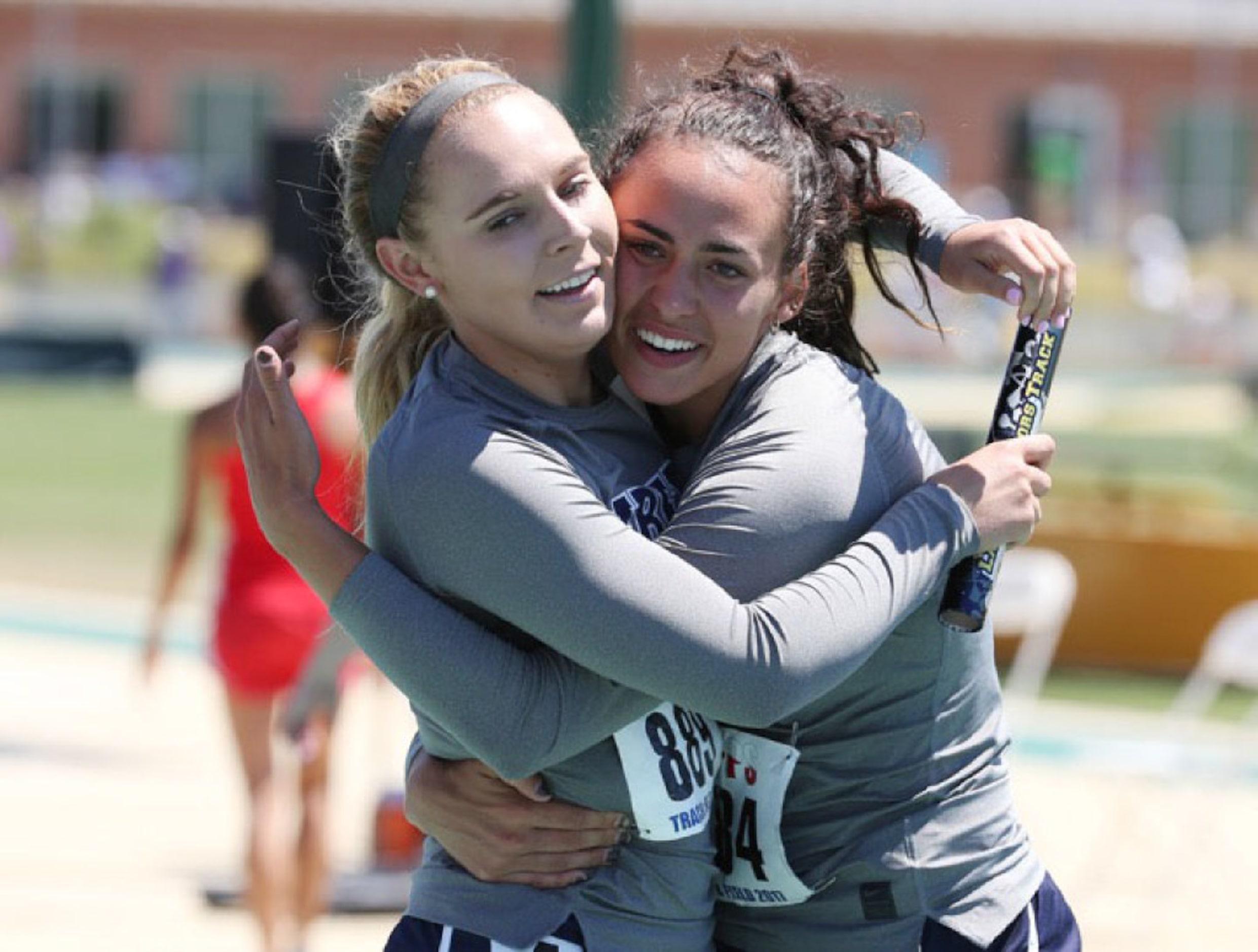 Liberty Christian's Maddie Willet, left, hugs teammate Lexi Mahon, right, after their first...