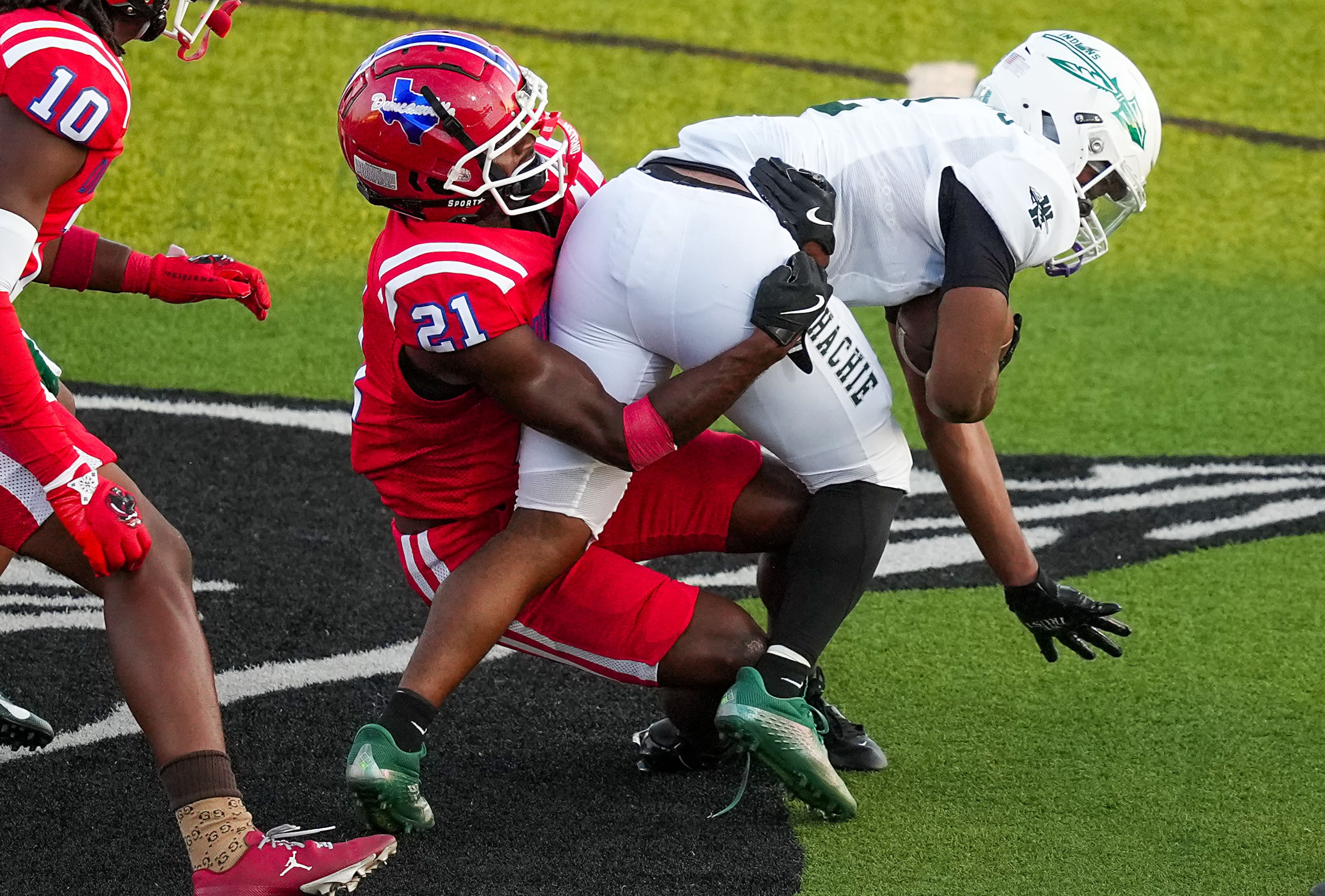 Duncanville defensive back Tyren Polley (21) brings down Waxahachie running back Wade Lemons...