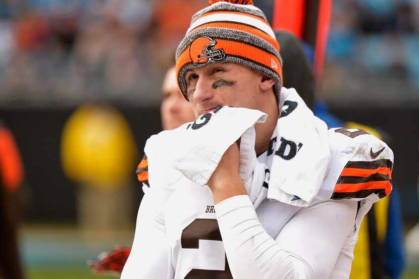 Johnny Manziel #2 of the Cleveland Browns watches from the bench during the second half of a...