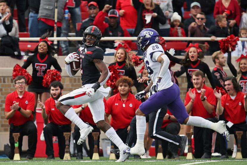 Texas Tech's RJ Turner (2) looks back on his way to scoring a touchdown during the first...