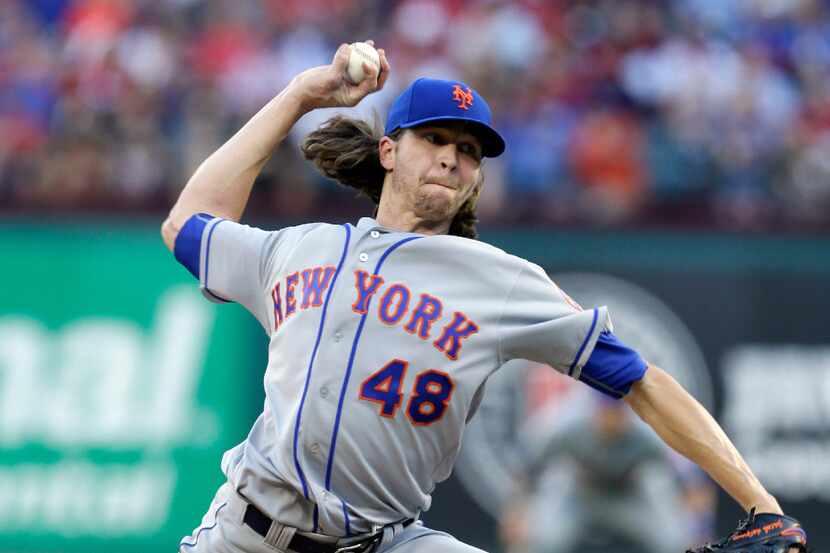 New York Mets starting pitcher Jacob deGrom throws to the Texas Rangers in the first inning...