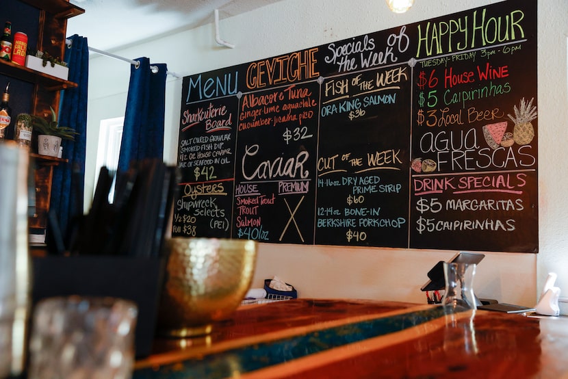 The chalkboard wall at La Onda displays the specials.