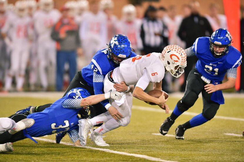 Krum senior linebacker Tylor Morris (33) and junior linebacker Ryan Gipson (42) drag down...