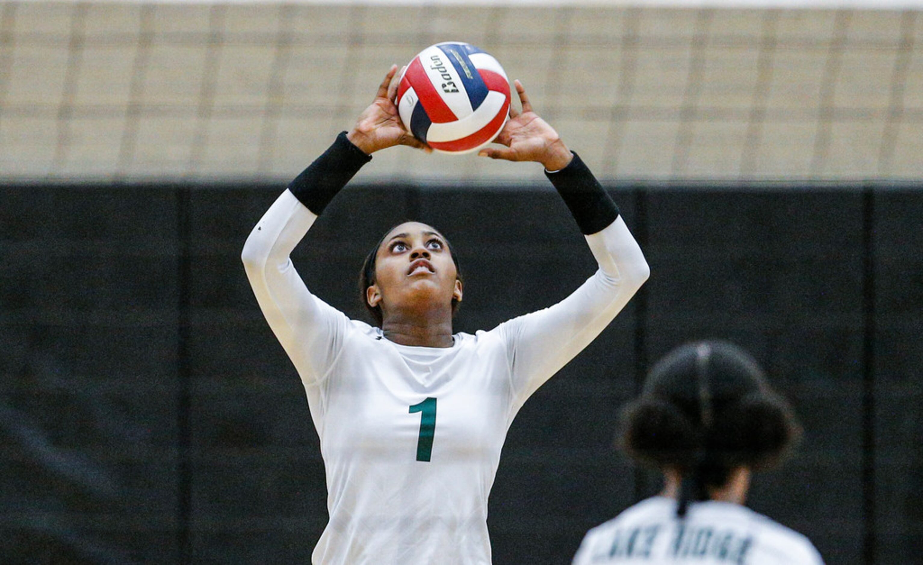 Mansfield Lake Ridge senior Madison Williams (1) sets the ball during a high school...