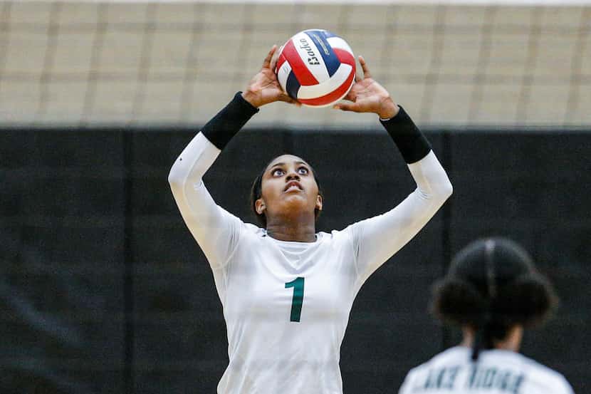 Mansfield Lake Ridge senior Madison Williams sets the ball during a match against North...