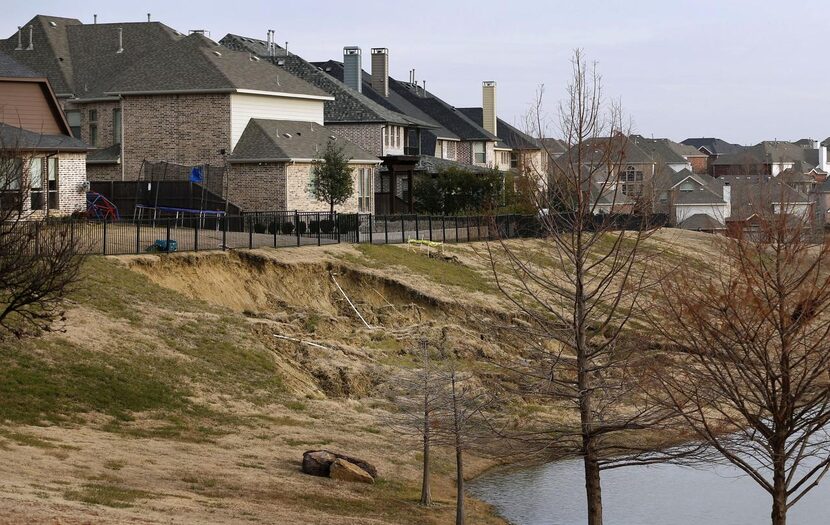 A view from the back of Brian Woodward's home where a failing slope creeps up on their...