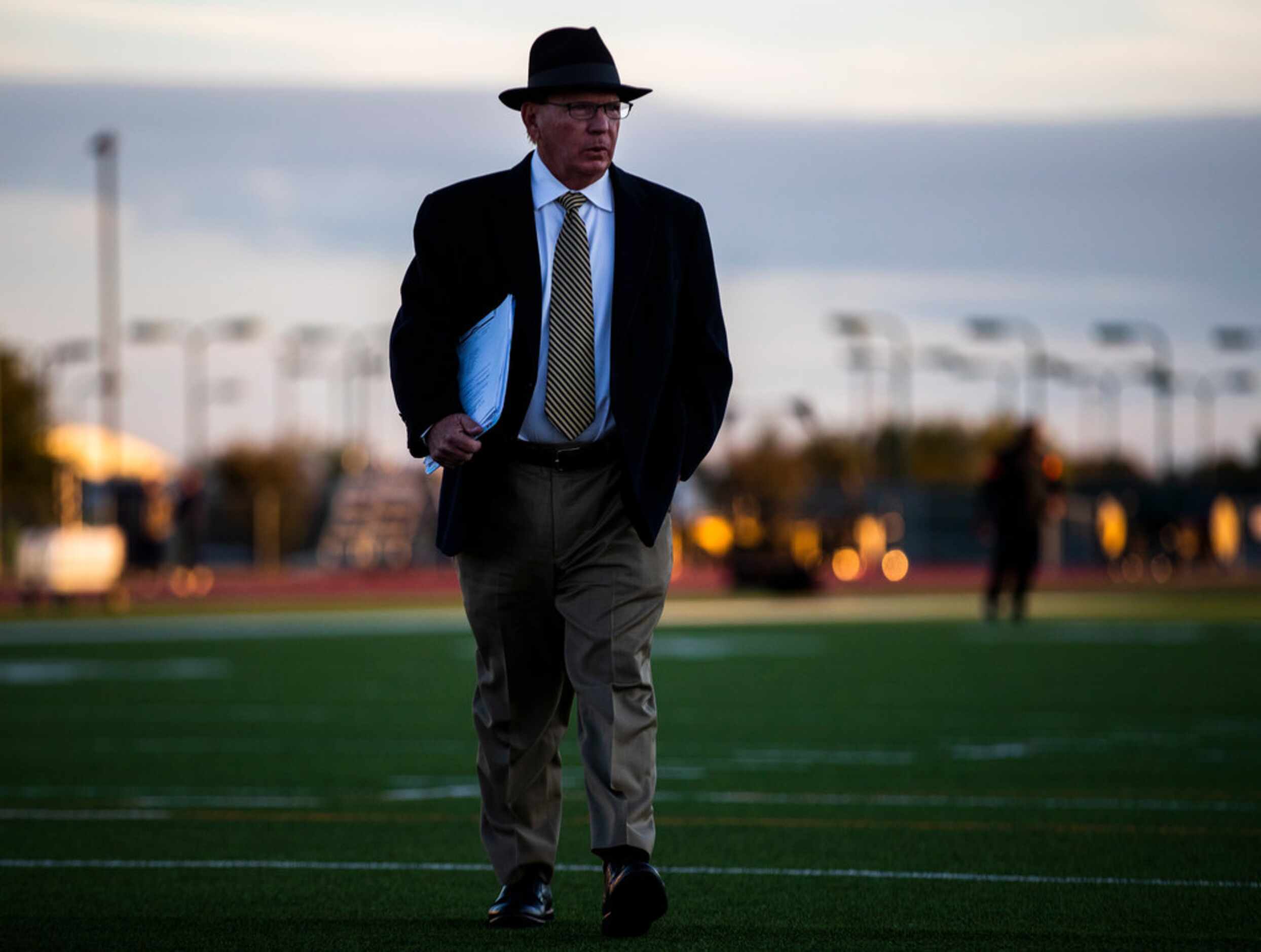 Highland Park head coach Randy Allen walks on the field as players warm up before a District...