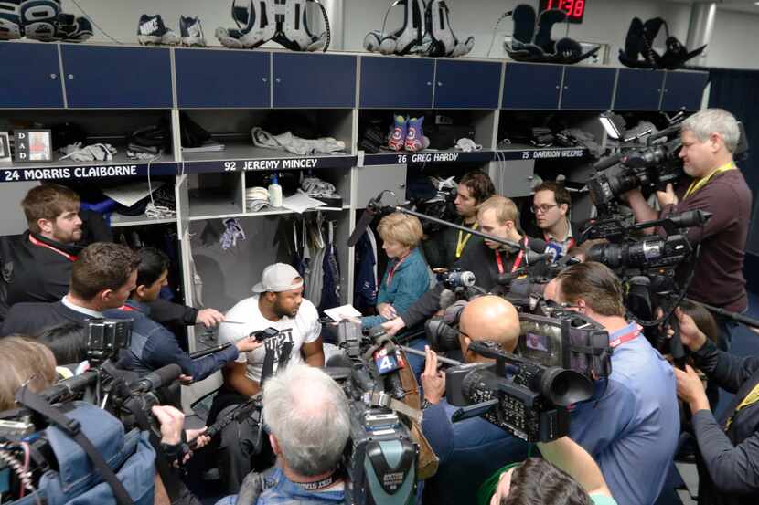Dallas Cowboys defensive end Jeremy Mincey talks to the news media in the locker room at...