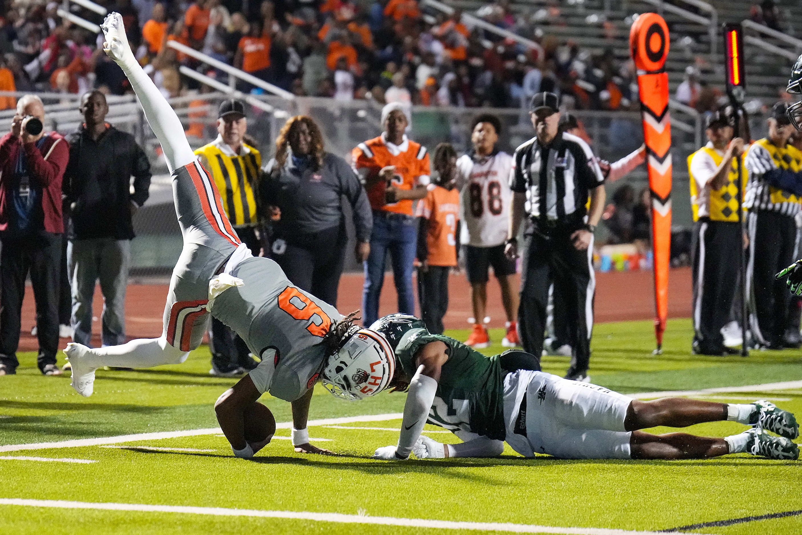 Lancaster quarterback Carter Jones (6) is upended by Waxahachie’s Michael Esparza Jr. (12)...