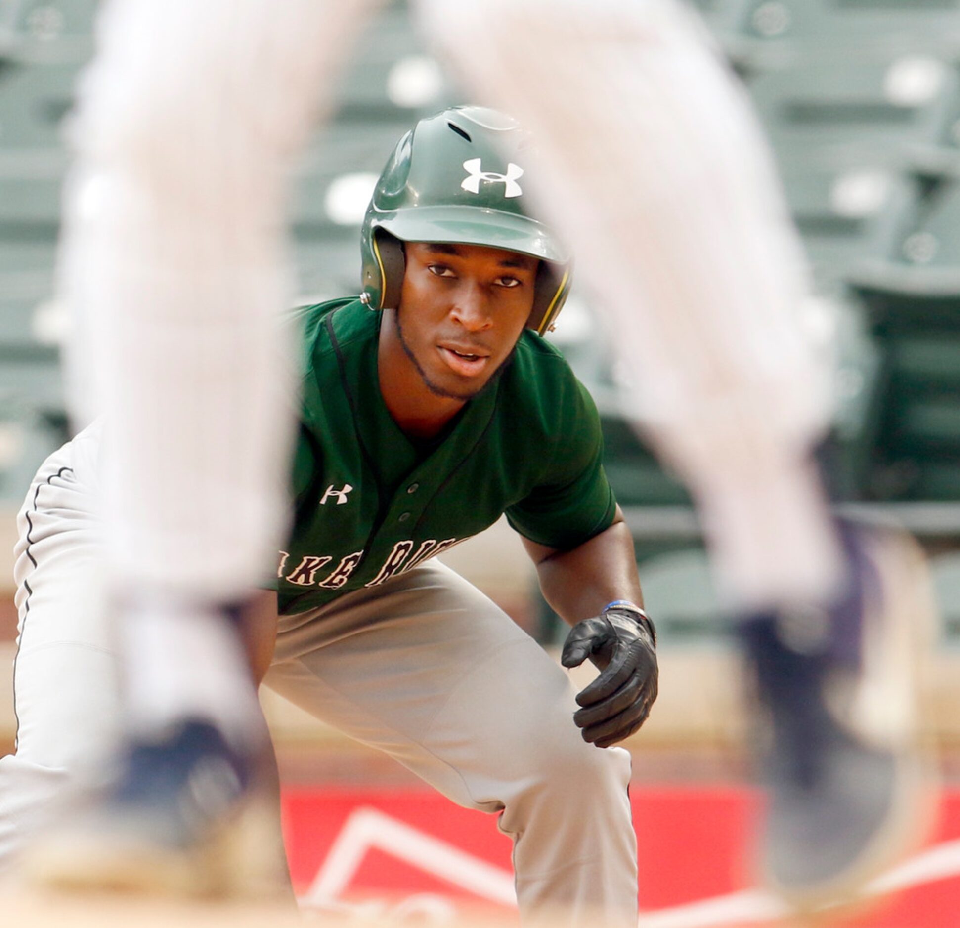 Mansfield Lake Ridge baserunner MJ Sterling (2) studies the windup of Flower Mound pitcher...