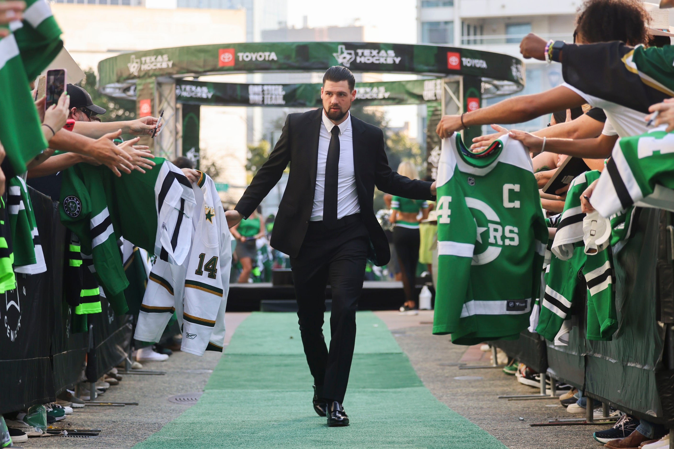 Dallas Stars left wing Jamie Benn high fives fans as he makes his way during the team’s home...