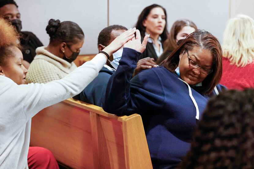 Shaquna Persley, right, mother of slain 13-year-old Shavon Randle, high-fives her daughter...