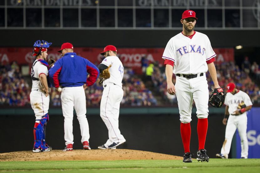 Texas Rangers relief pitcher Tom Wilhelmsen walks of the field after being pulled from the...