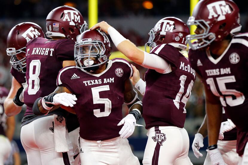 Texas A&M Aggies running back Trayveon Williams (5) is congratulated by teammates on his...