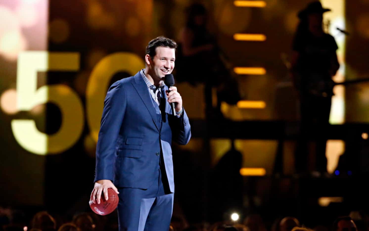 Dallas Cowboys quarterback Tony Romo stands on stage during the 2015 Academy of Country...