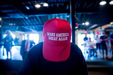 A Donald Trump supporter flashes a hat less typical for Gilley's Dallas at a rally last month.