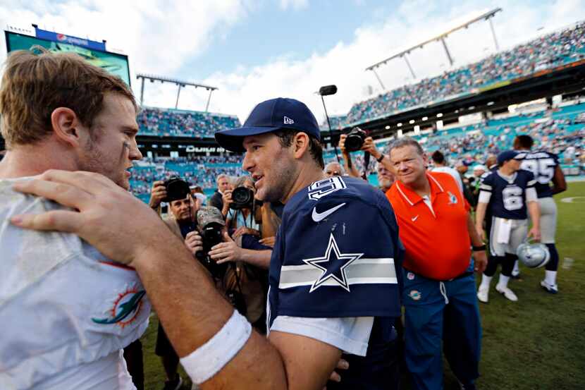 Dallas Cowboys quarterback Tony Romo (9) shakes hands with Miami Dolphins quarterback Ryan...