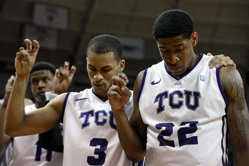 TCU guards Clyde Smith III (3) and Jarvis Ray (22) listen to the alma mater after a game...