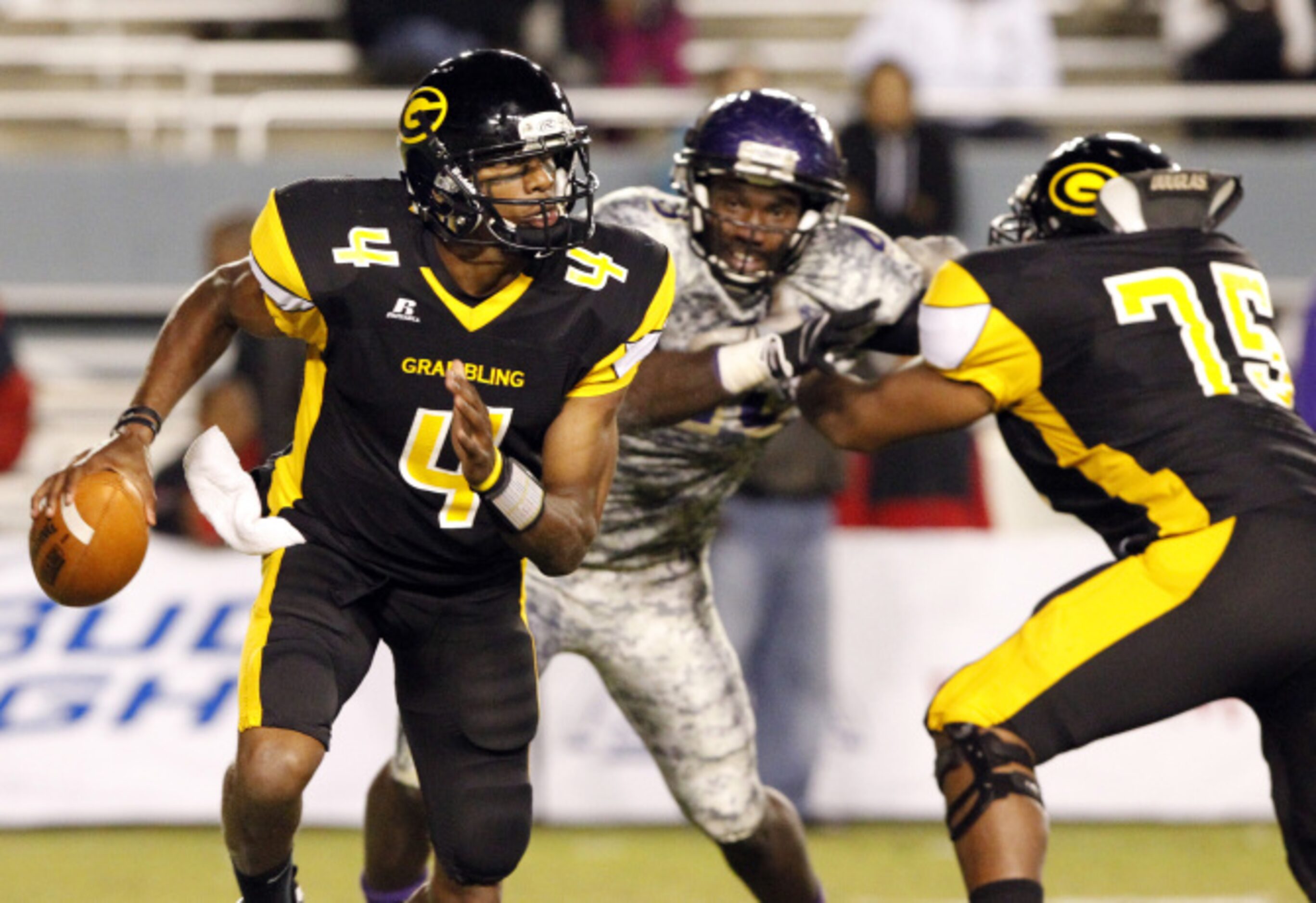 Grambling quarterback D.J. Williams (4) scrambles with the ball, as Prairie View A&M...