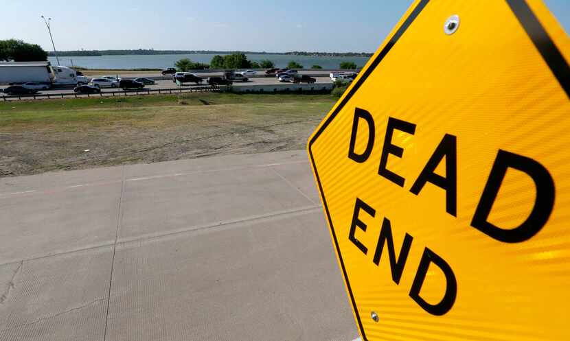 A dead end sign of the Interstate 30 frontage road is seen near Bass Pro Drive as evening...