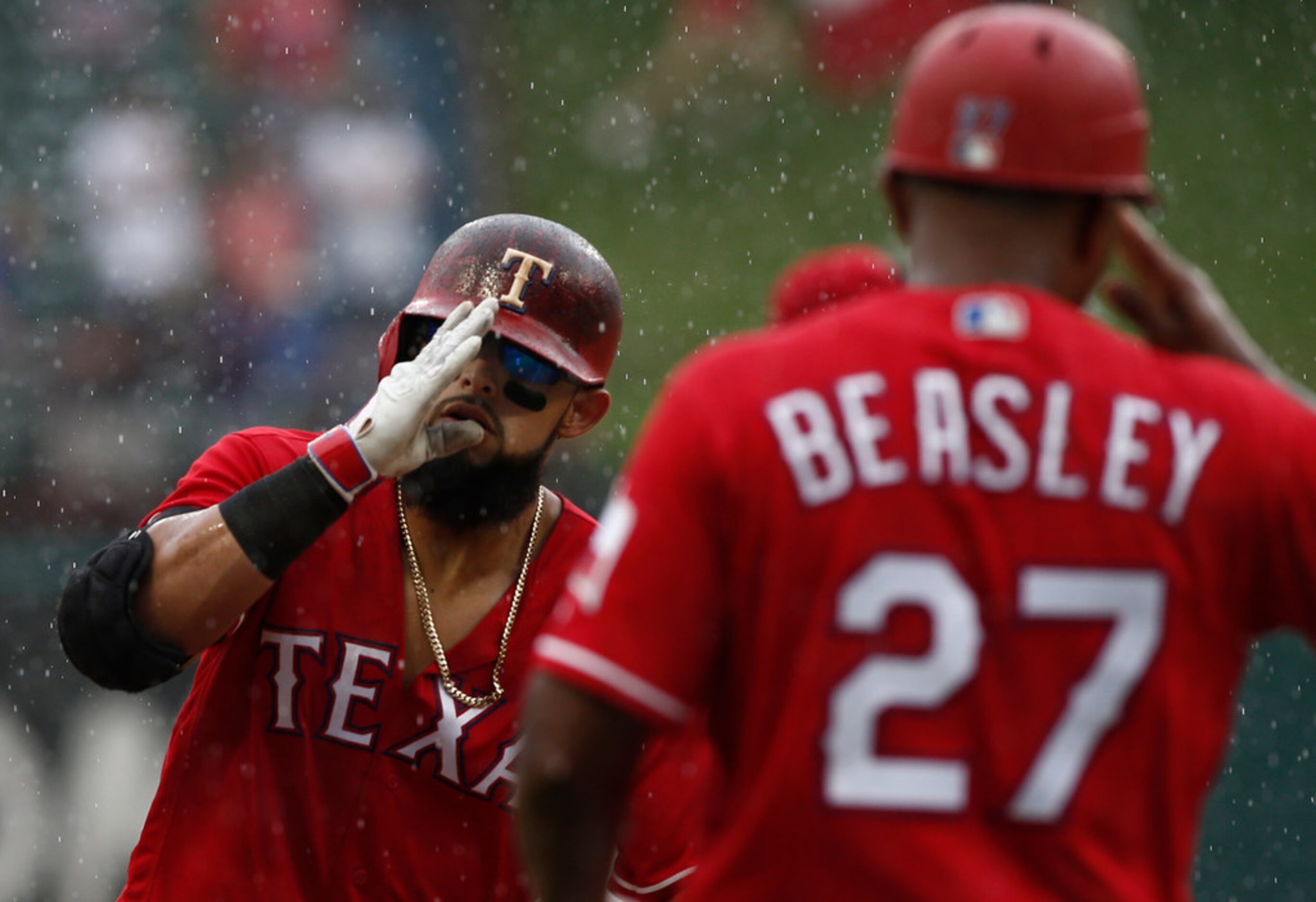 Texas Rangers' Rougned Odor is congratulated by third base coach Tony Beasley (27) after he...