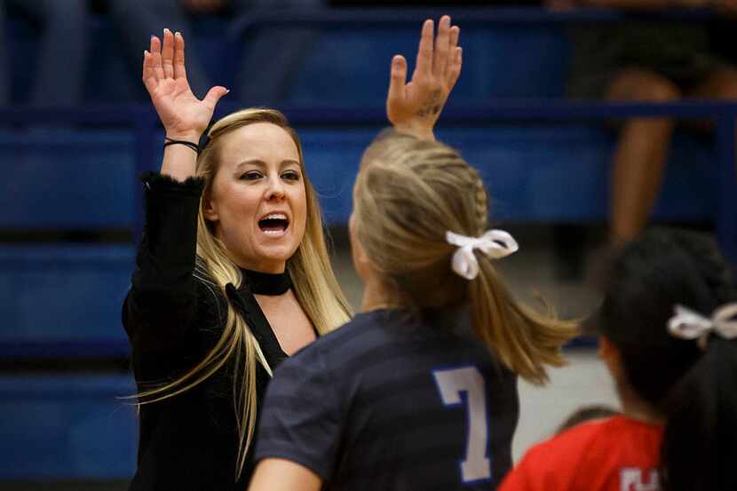 Plano West coach Brittany Rodriguez (formerly Bridge) high-fives Jill Pressly (7) before a...