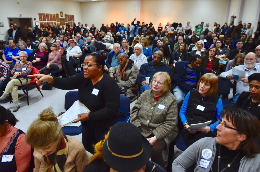 Camile White, precinct chair for 1093, (front left) stands to ask a question about a lawsuit...