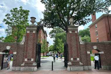 Students walk through a gate at Harvard University, Thursday, June 29, 2023, in Cambridge,...