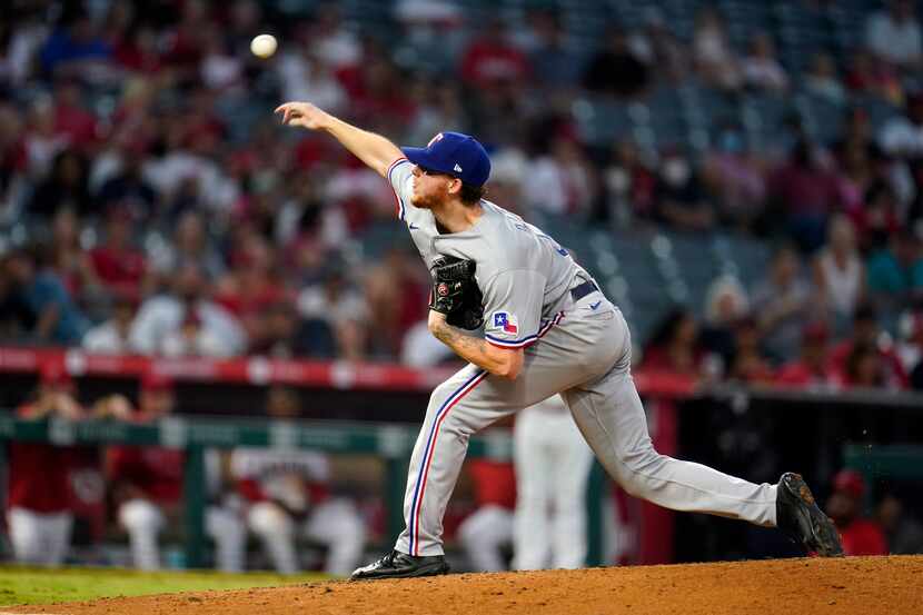Texas Rangers starting pitcher A.J. Alexy throws to the Los Angeles Angels during the fourth...
