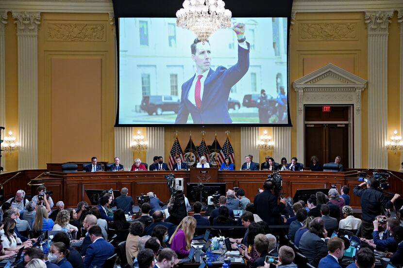 A photo of Sen. Josh Hawley, R-Mo., signaling his solidarity with protesters, is displayed...