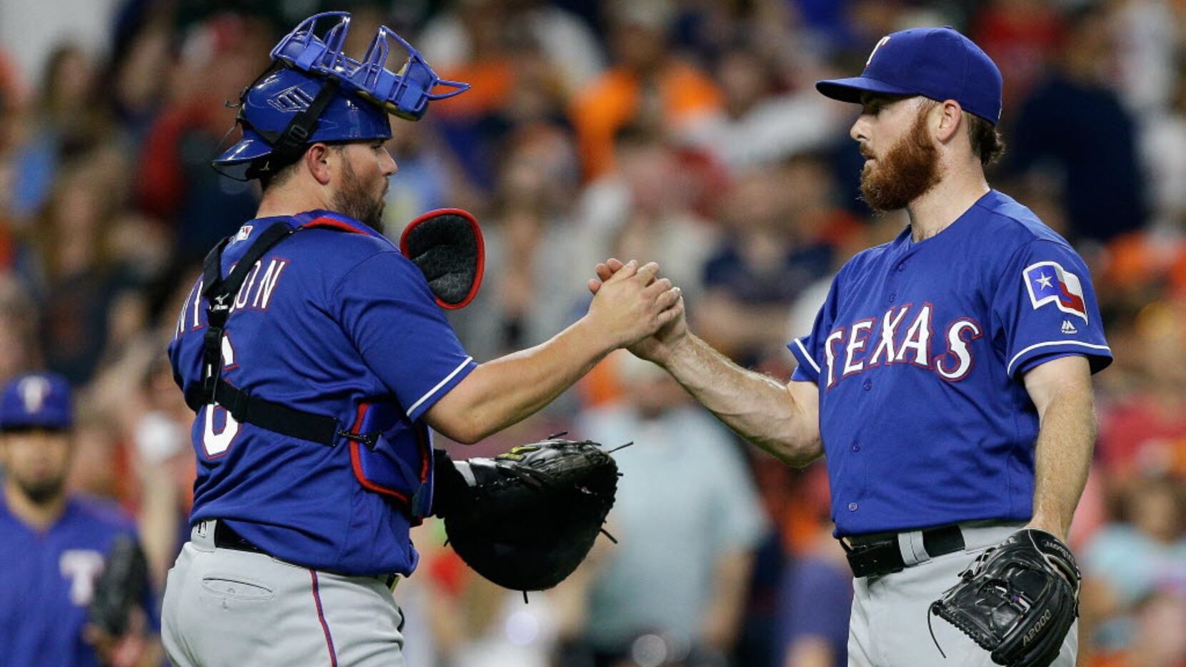 HOUSTON, TX - MAY 20:  Sam Dyson #47 of the Texas Rangers, right, shakes hands with catcher...