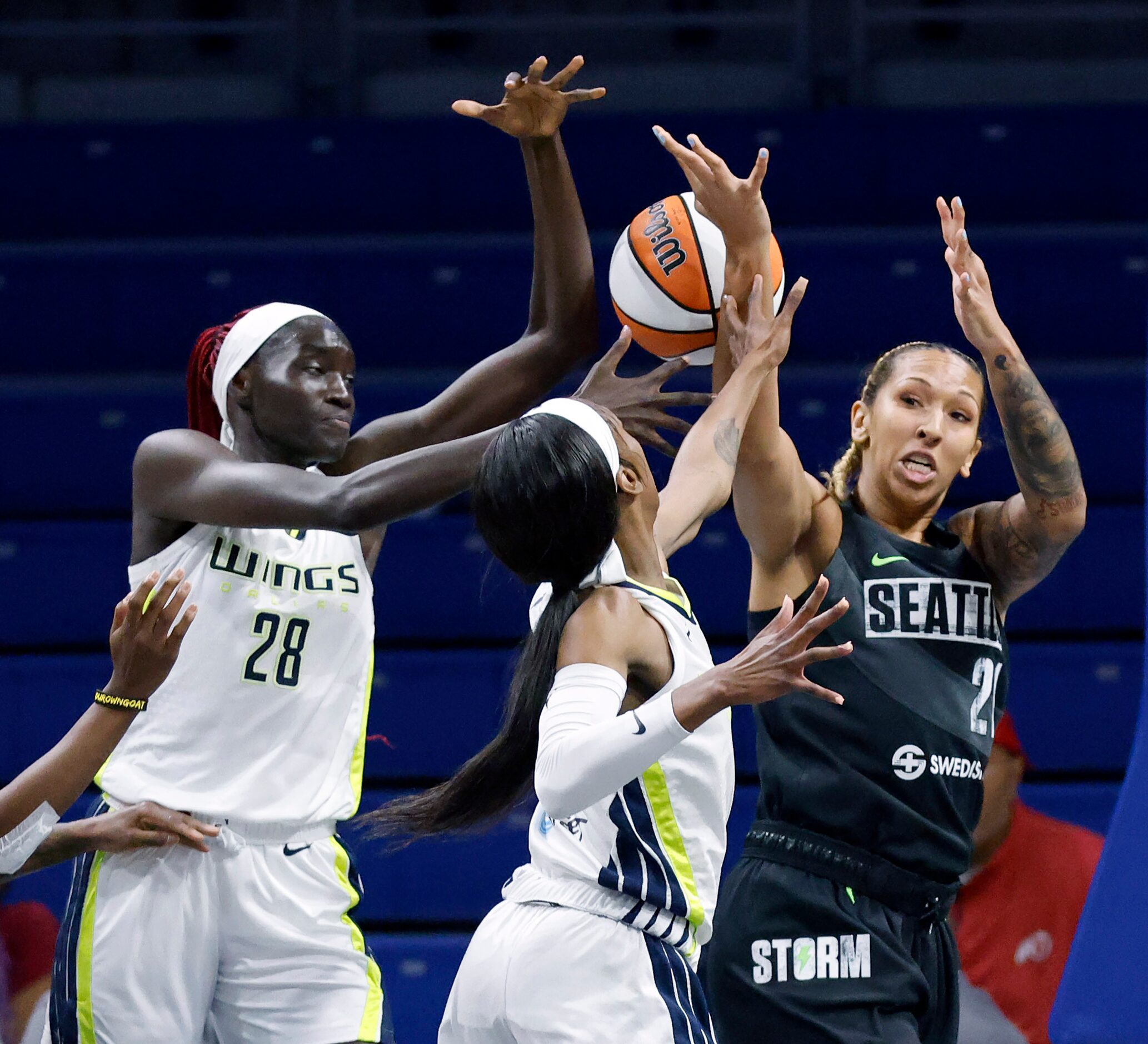 Dallas Wings center Awak Kuier (28), guard Jasmine Dickey (23) battle Seattle Storm center...