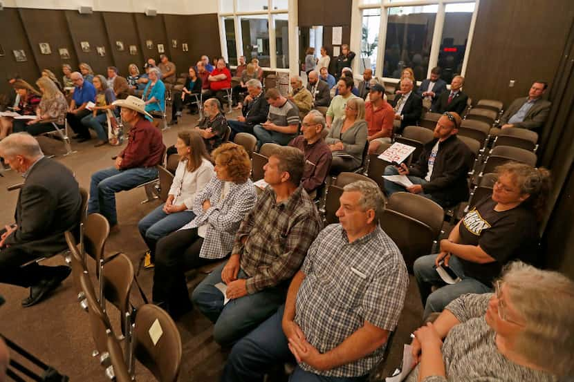 The crowd listens to Rep. Joe Barton during a town hall meeting at Corsicana Government...