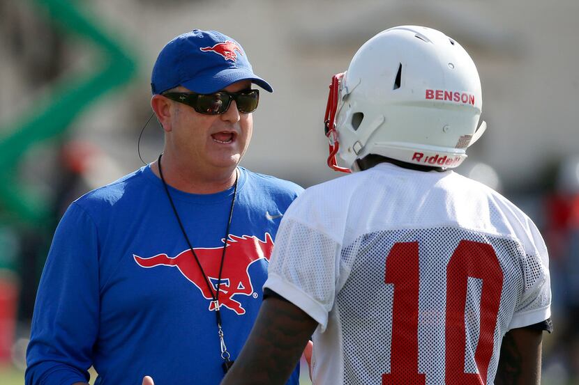 SMU head football coach Sonny Dykes, left, talks with wide receiver Brandon Benson during...