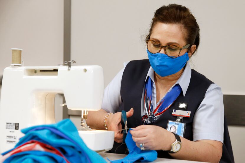 American Airlines employee Beatrice Austin makes masks for employees at DFW International...