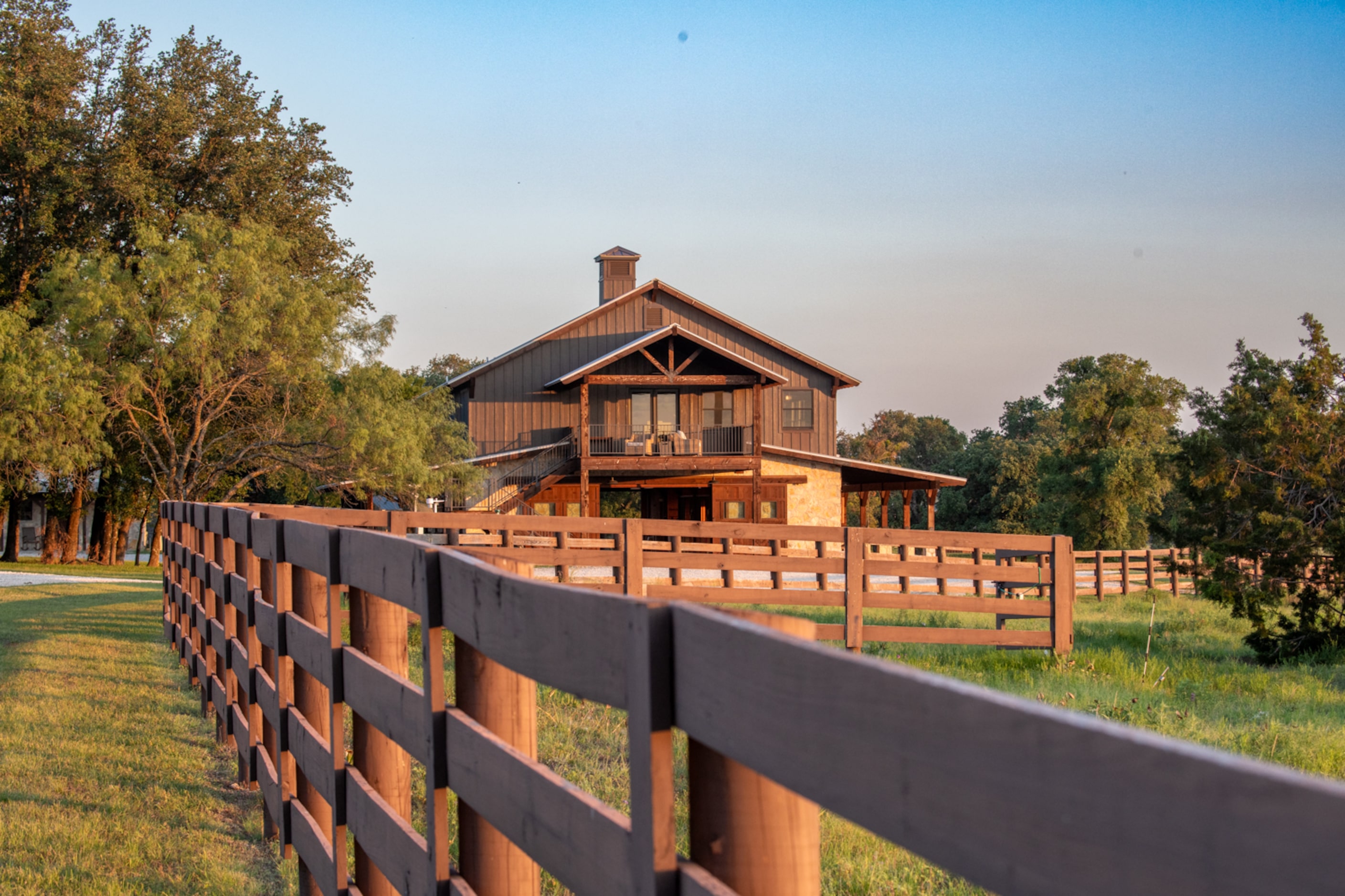 Fencing throughout the property reflects the aesthetic of the architectural choices.