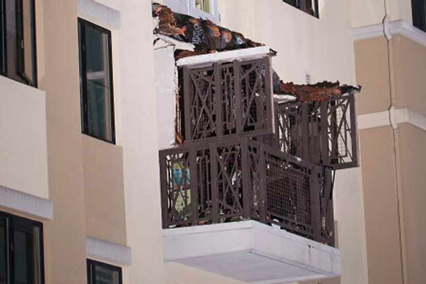 This image shows a close-up view of a fourth floor balcony that collapsed onto the balcony...