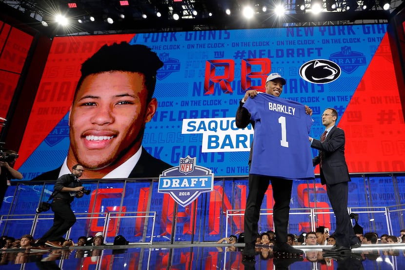 Penn State's Saquon Barkley poses after being selected by the New York Giants during the...