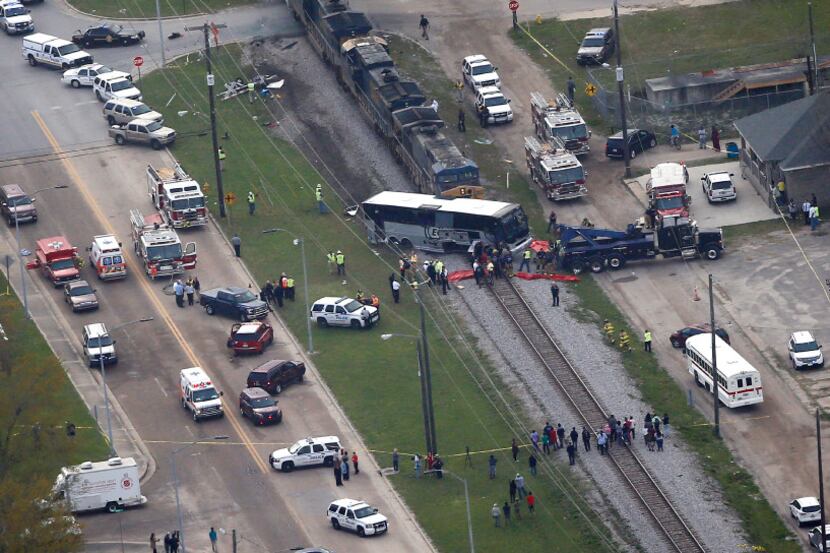 Responders works the scene where a train hit a bus in Biloxi, Miss., Tuesday.  (Gerald...