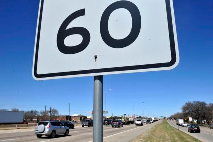 Speed limit signs read 60 mph on the North Central Expressway as cars rush past. TxDOT is...