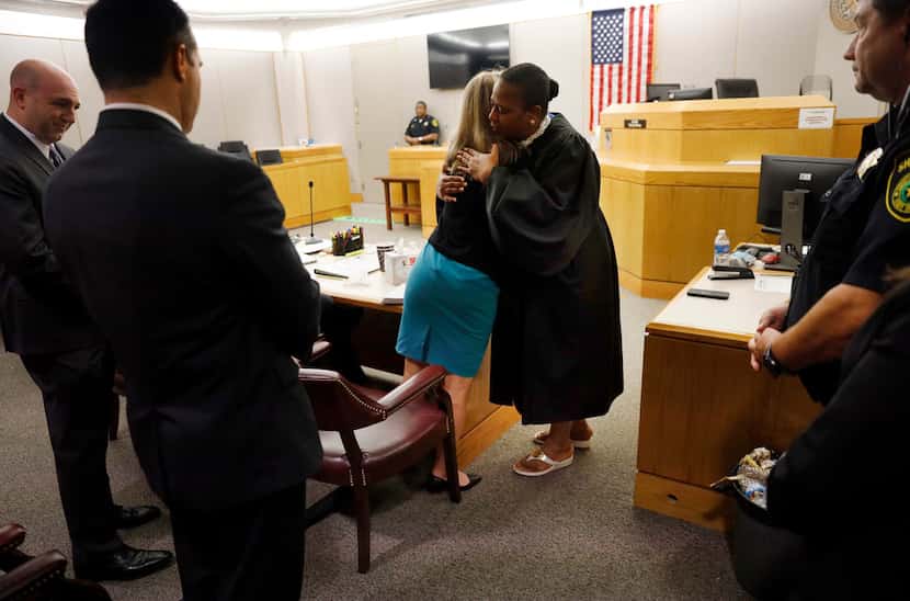 Amber Guyger and District Judge Tammy Kemp embraced Wednesday after the end of Guyger's...
