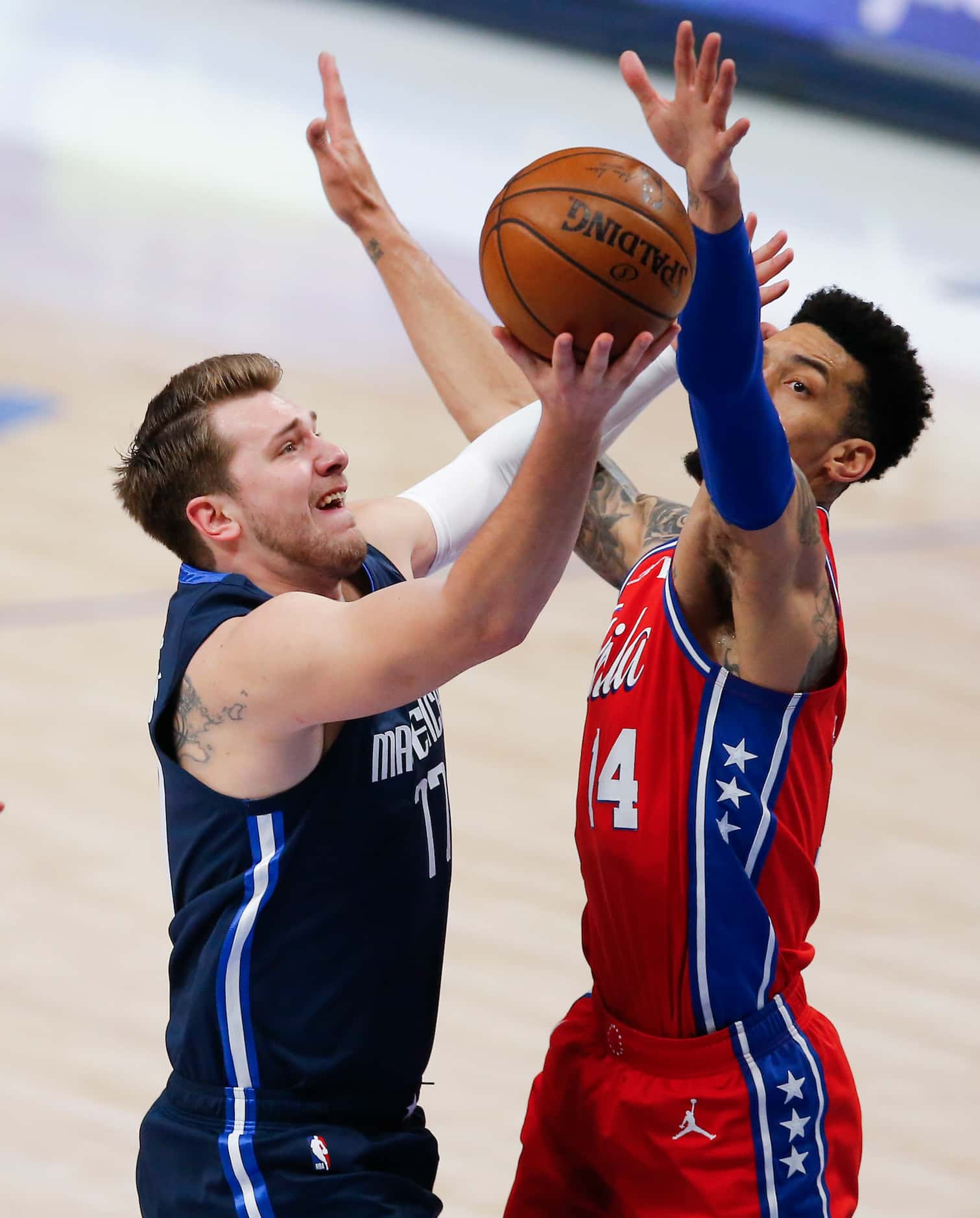 Dallas Mavericks guard Luka Doncic (77) attempts a shot as Philadelphia 76ers forward Danny...