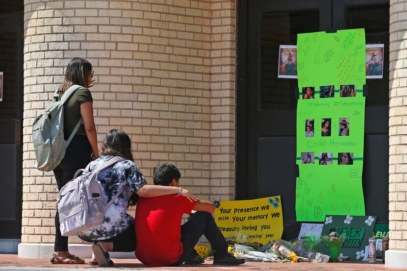 In this Sept. 3, 2019 photo, people gather at a memorial for slain high school student...