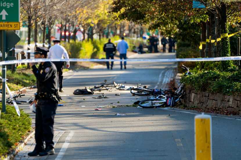 Bicycles and debris lay on a bike path after a motorist drove onto the path near the World...