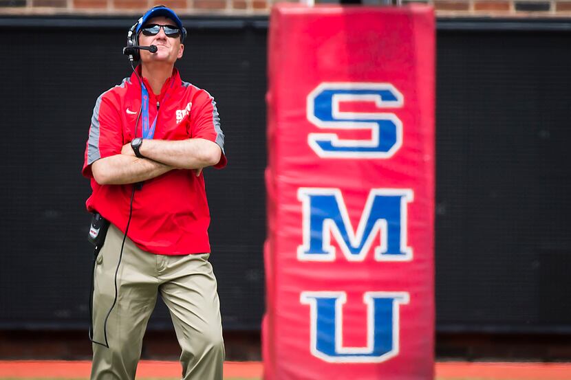 SMU head coach Chad Morris watches his players scrimmage during the team's spring football...