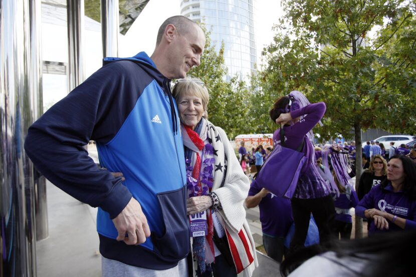 Mitchell embraced Dallas Mavericks head coach Rick Carlisle following his talk at a 5K...