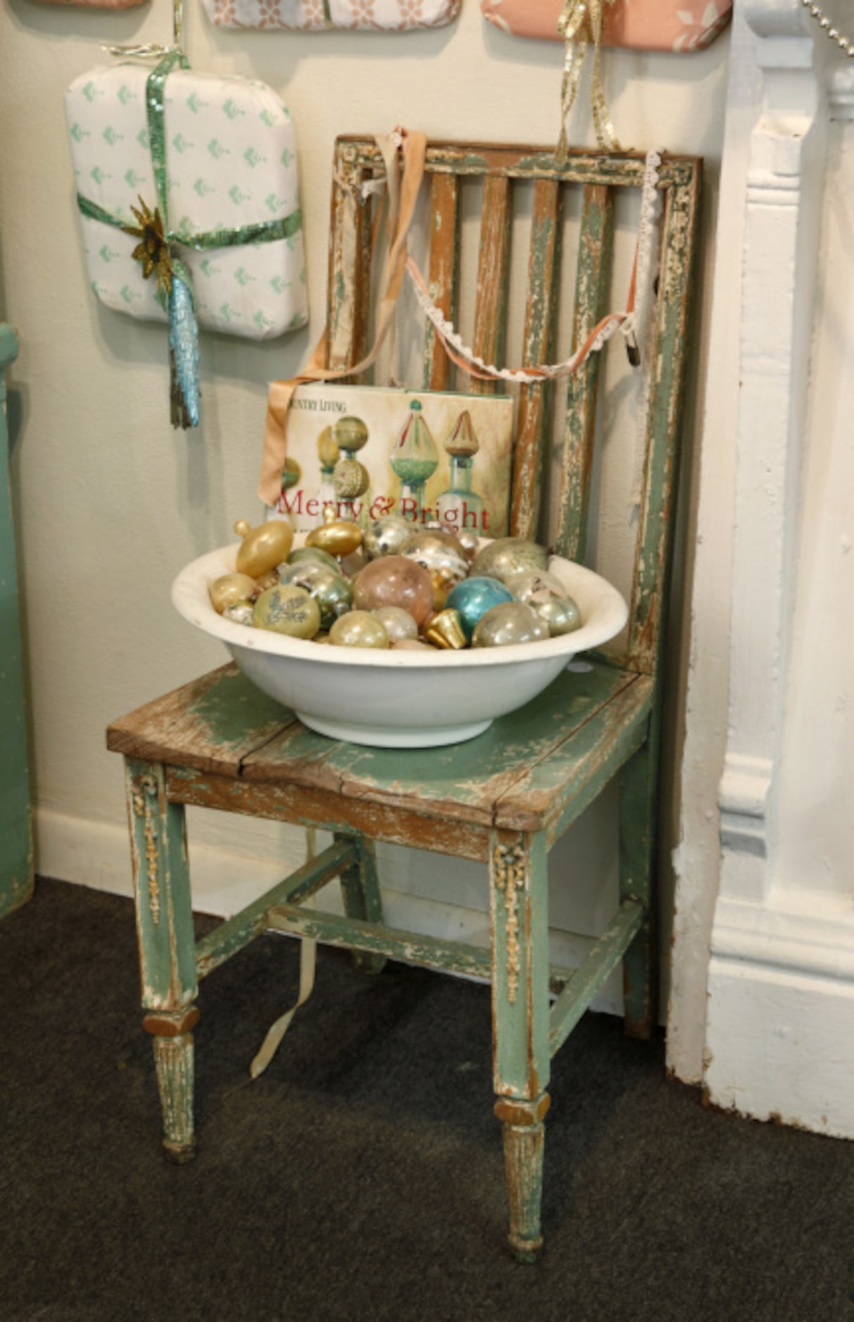 Christmas ornaments displayed on a shabby chair.