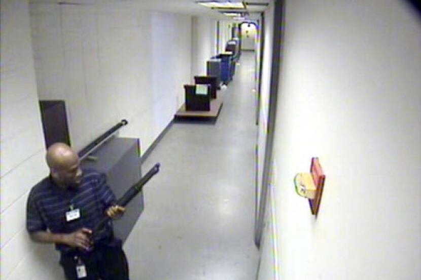 This image from video provided by the FBI, shows Aaron Alexis moves through the hallways of...