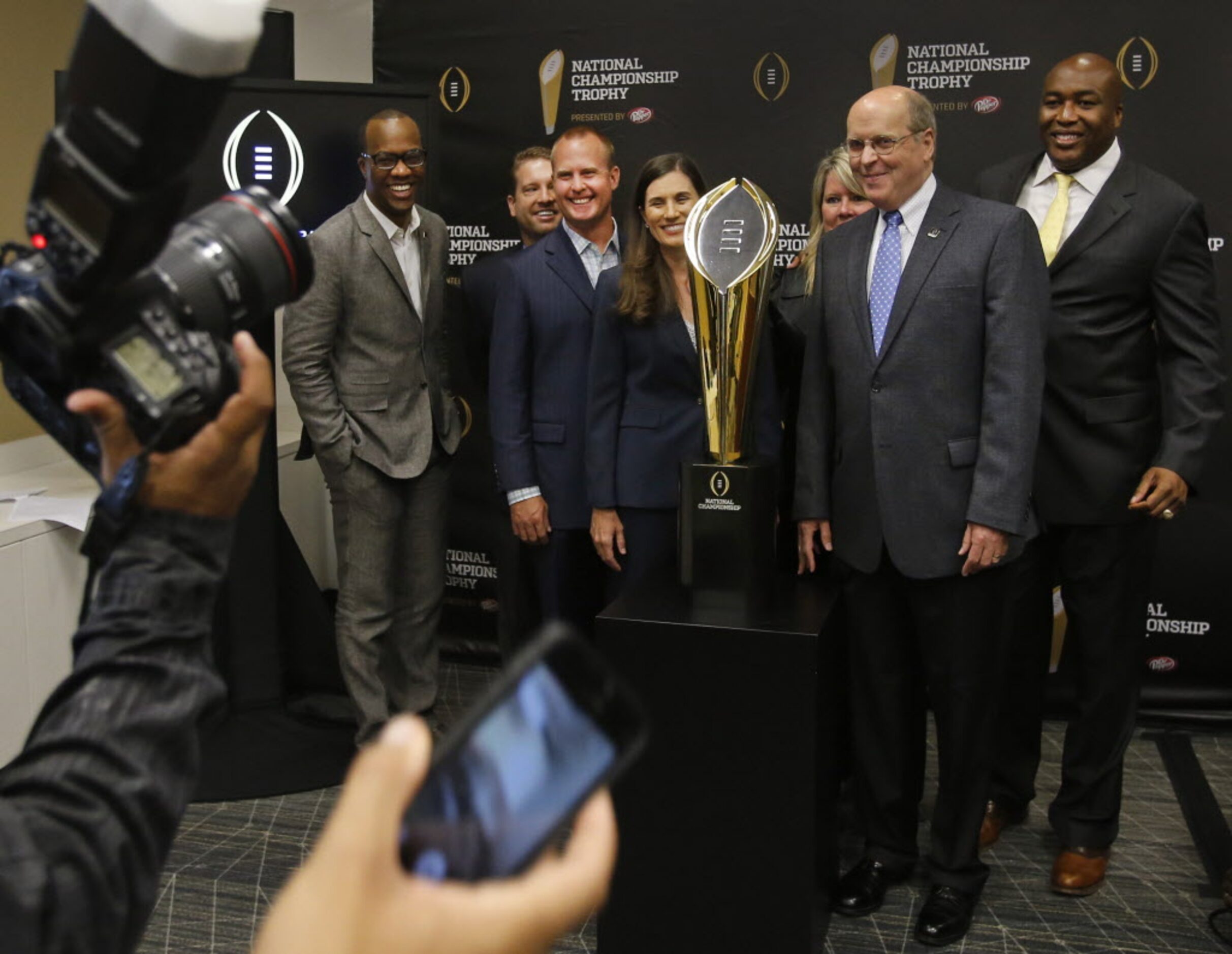 College Football Playoff executive director Bill Hancock, second from right, poses with...