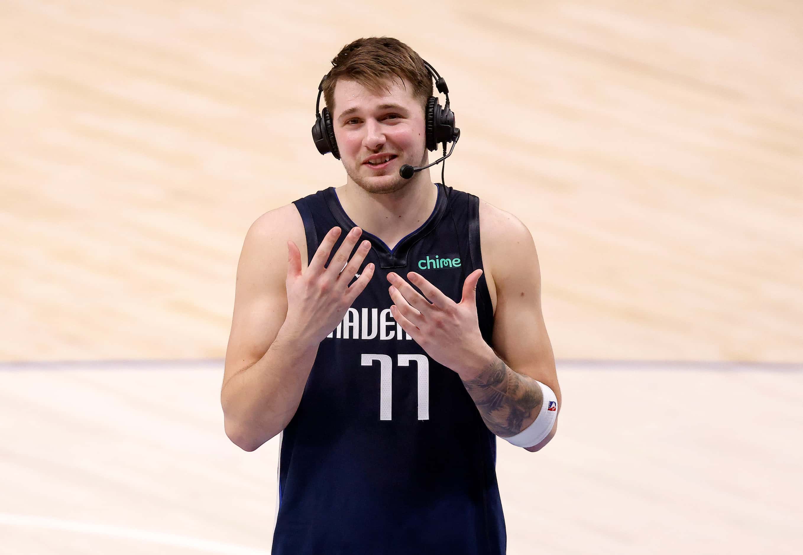 Dallas Mavericks guard Luka Doncic (77) smiles as he responds to media questions following...